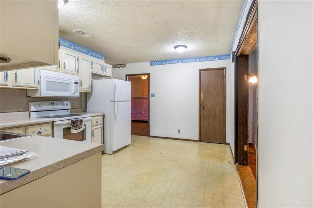 12379 Chapman Road Tyler, TX 75708 - Photo 13 of 40 a kitchen with refrigerator and microwave