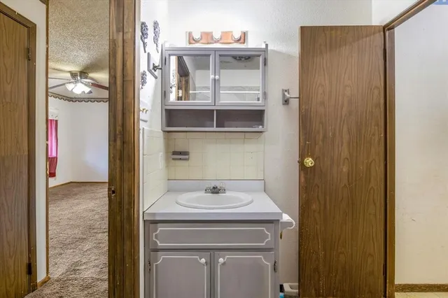a utility room with a sink and cabinets