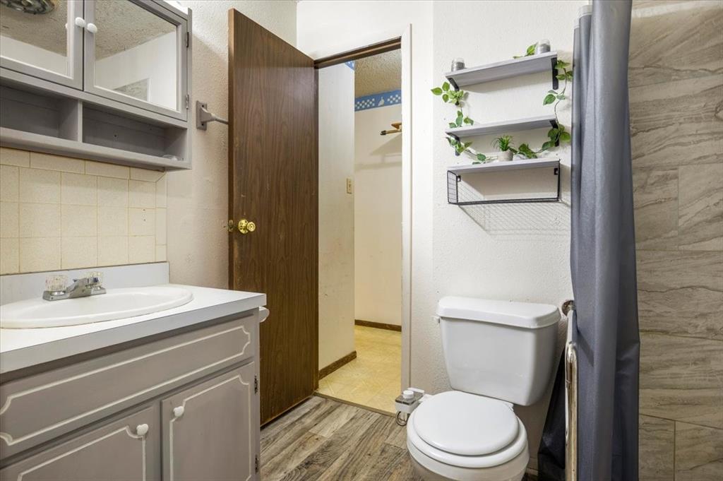 12379 Chapman Road Tyler, TX 75708 - Photo 16 of 40 a white toilet sitting next to a bathroom sink