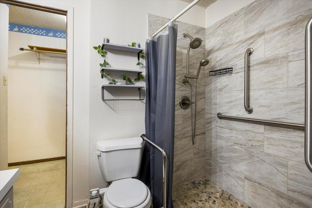 12379 Chapman Road Tyler, TX 75708 - Photo 17 of 40 a bathroom with a shower and toilet