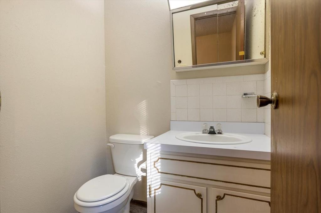 12379 Chapman Road Tyler, TX 75708 - Photo 22 of 40 a bathroom with a sink toilet and mirror