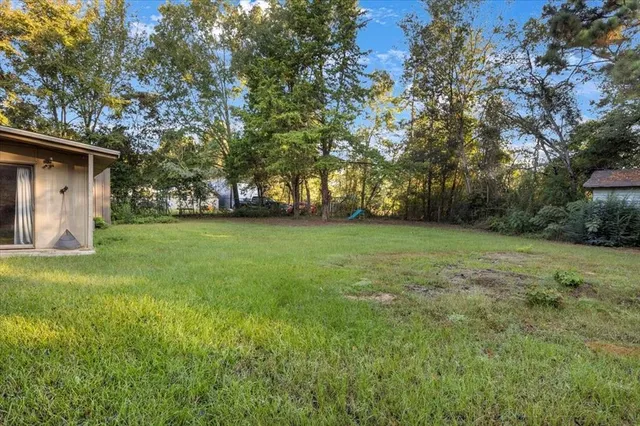 a view of a house with yard and sitting area