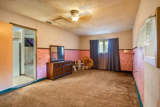 a view of a livingroom with furniture and a flat screen tv