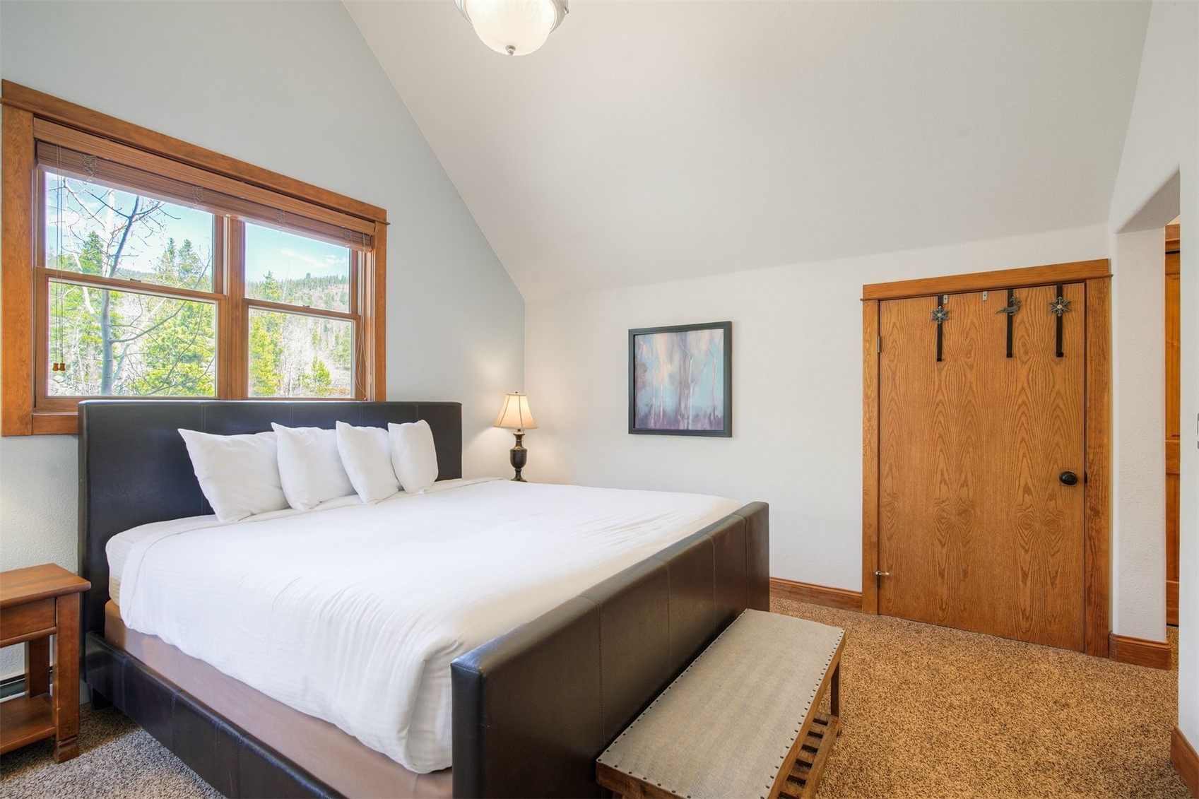 71 Antlers Gulch Road, Unit 303 Keystone, CO 80435 - Photo 21 of 35 a large bedroom with a bed and a window