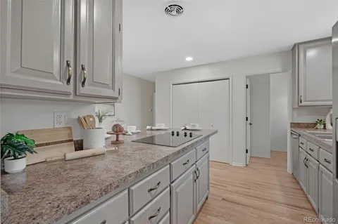 a kitchen with granite countertop a sink and a stove