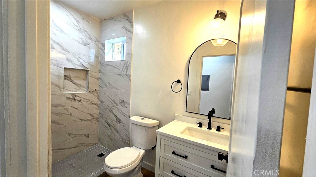 11171 Bullis Road Lynwood, CA 90262 - Photo 7 of 15 a bathroom with a sink mirror vanity and toilet