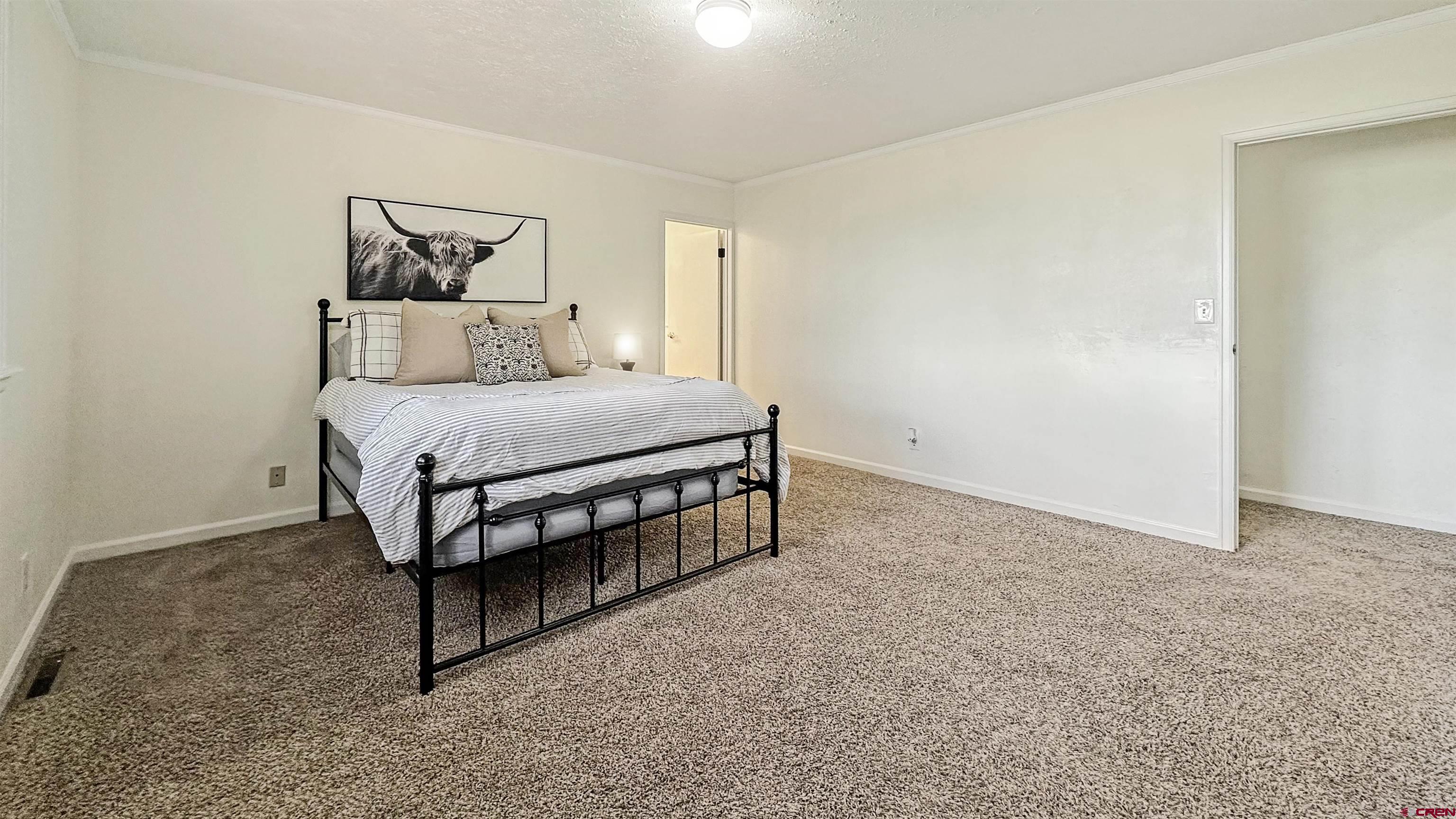 629 Norwood Road Montrose, CO 81403 - Photo 13 of 38 a bedroom with a bed and window