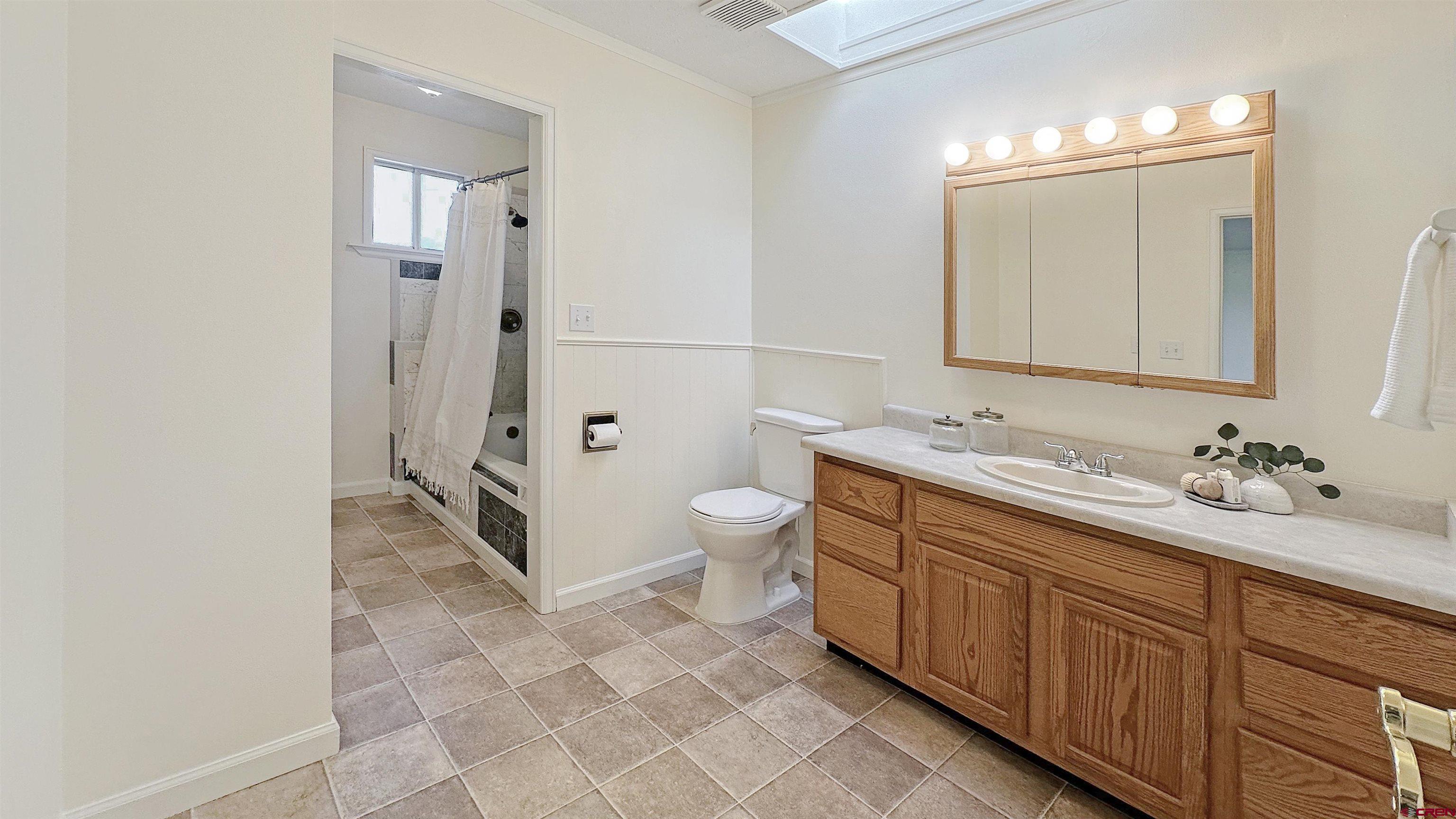 629 Norwood Road Montrose, CO 81403 - Photo 14 of 38 a spacious bathroom with a granite countertop sink a toilet and a shower