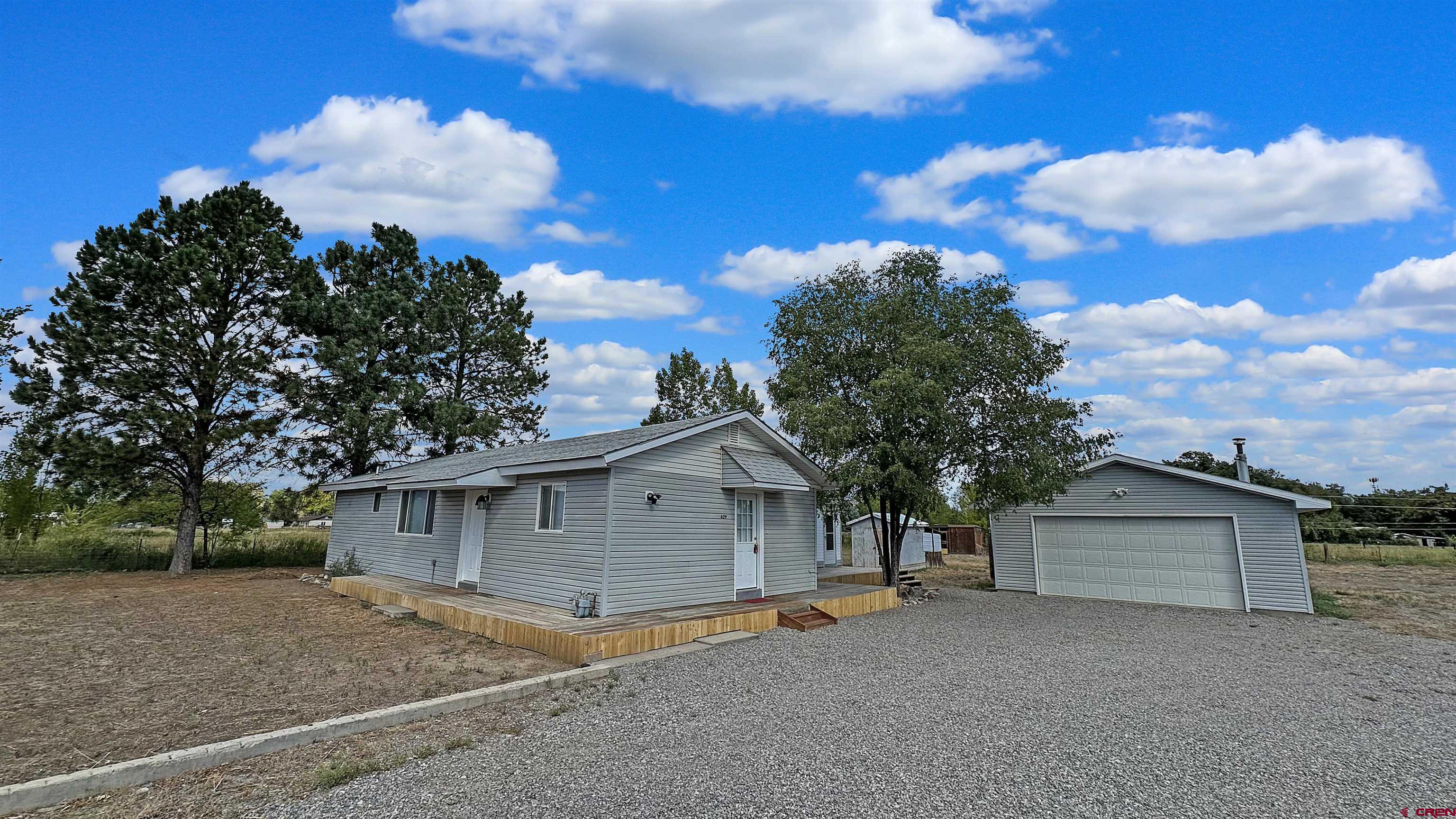 629 Norwood Road Montrose, CO 81403 - Photo 2 of 38 a view of a house with a yard and large tree
