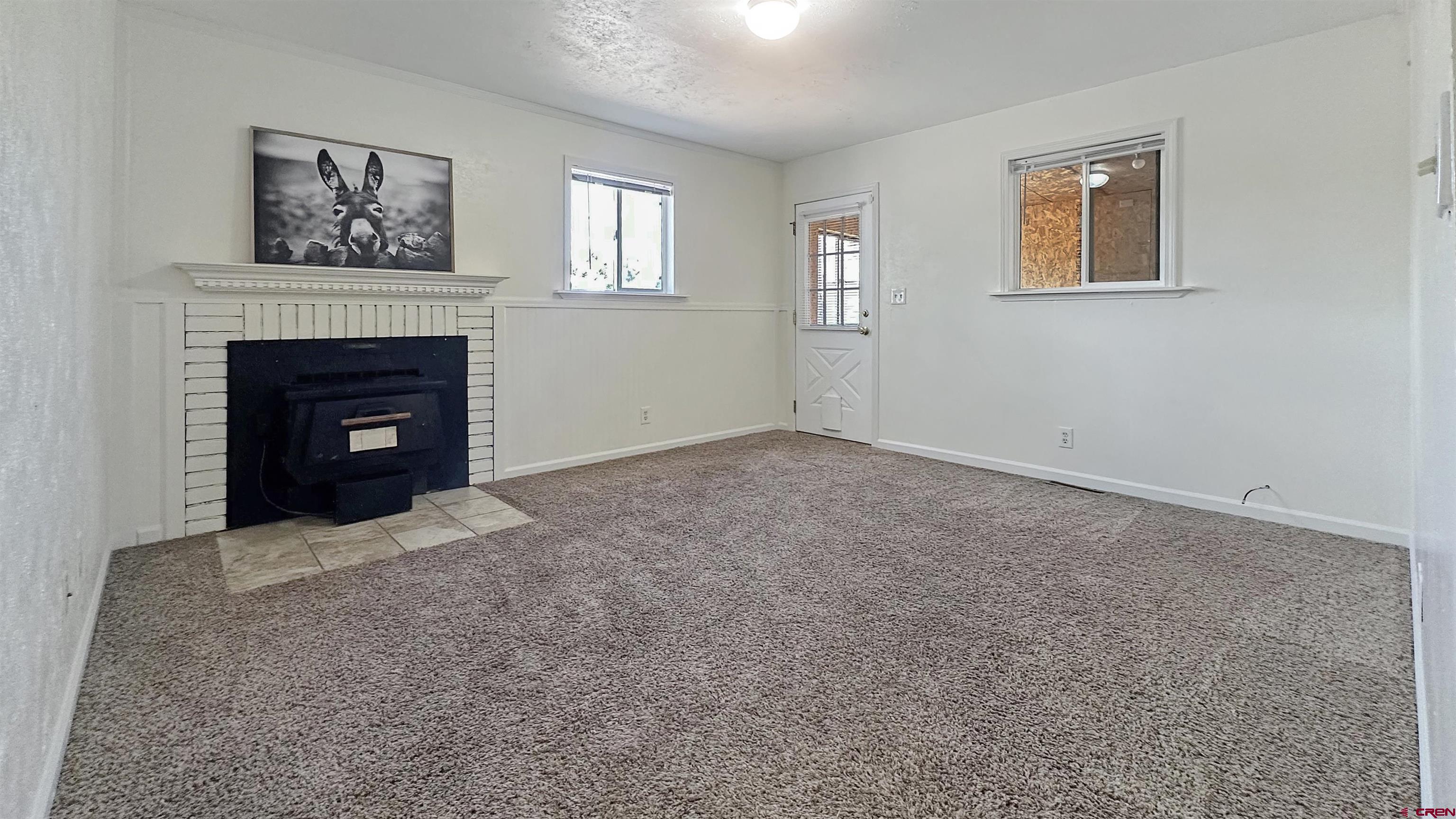 629 Norwood Road Montrose, CO 81403 - Photo 23 of 38 a living room with furniture and a fireplace