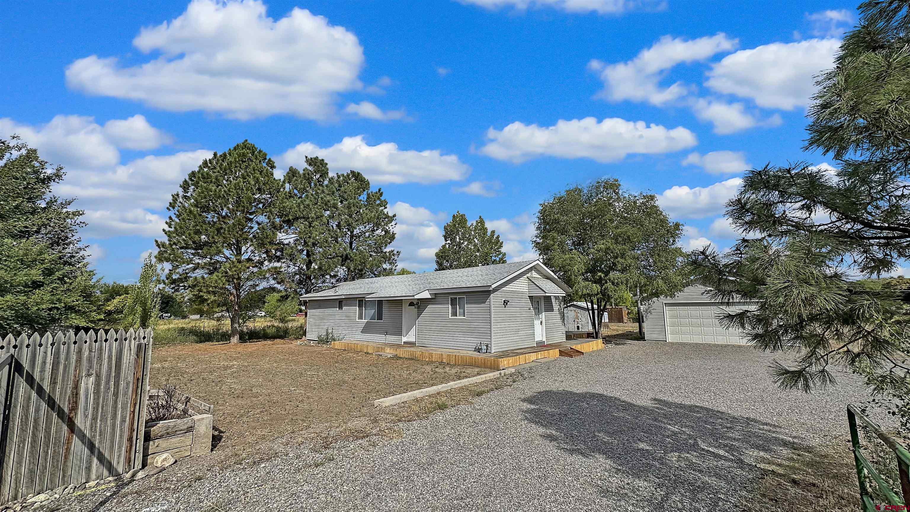629 Norwood Road Montrose, CO 81403 - Photo 3 of 38 a front view of a house with a yard