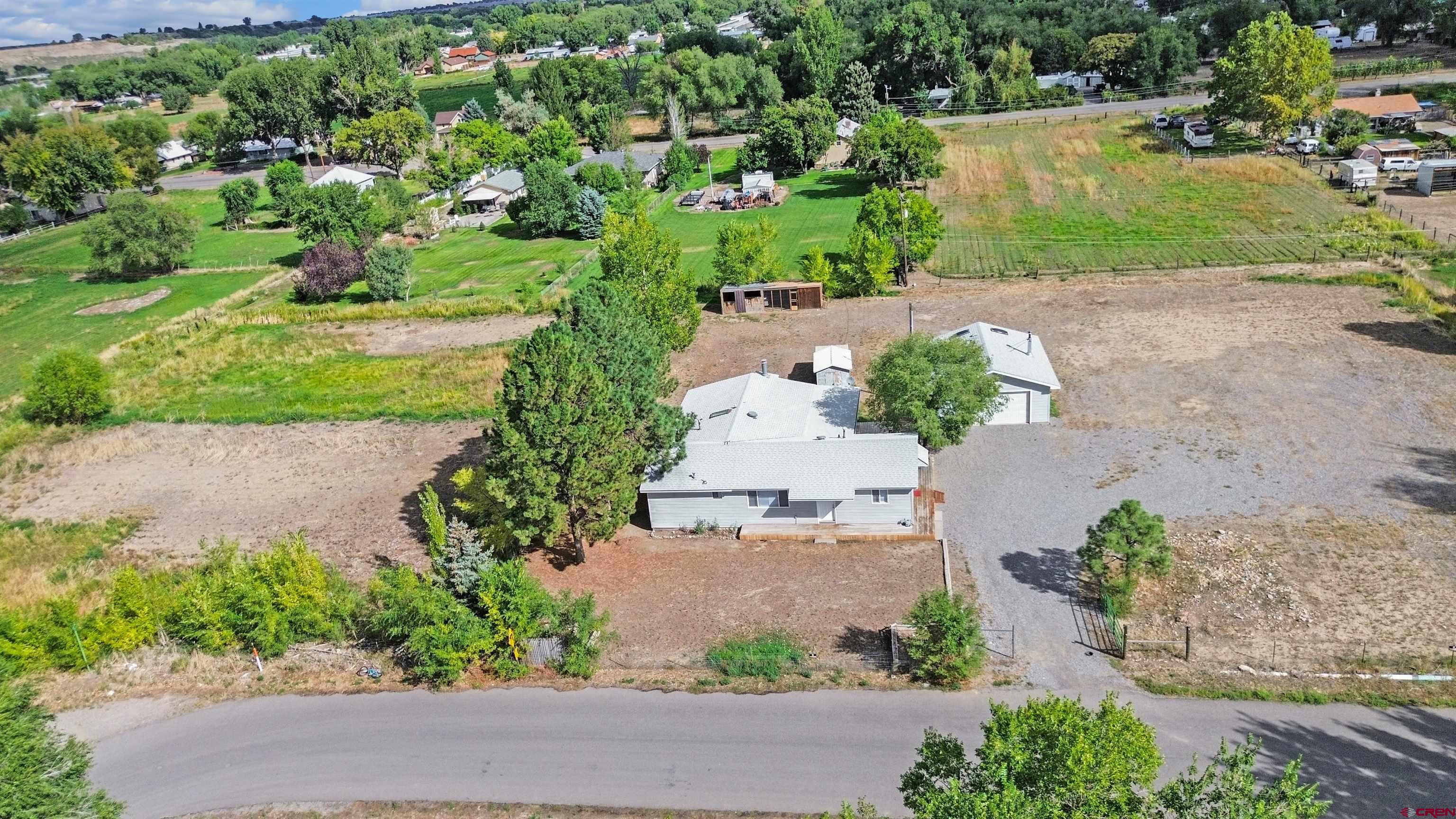 629 Norwood Road Montrose, CO 81403 - Photo 31 of 38 an aerial view of a house with a yard and garden