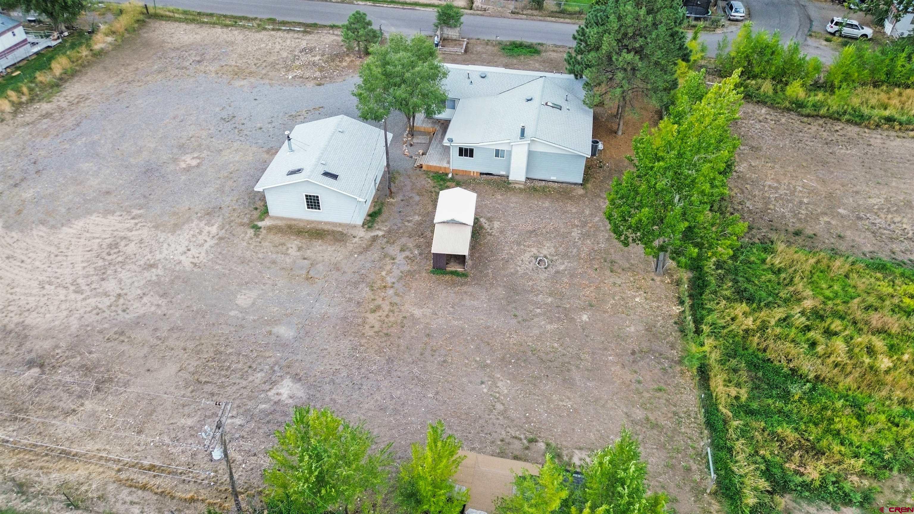 629 Norwood Road Montrose, CO 81403 - Photo 35 of 38 an aerial view of a house with a yard and large tree