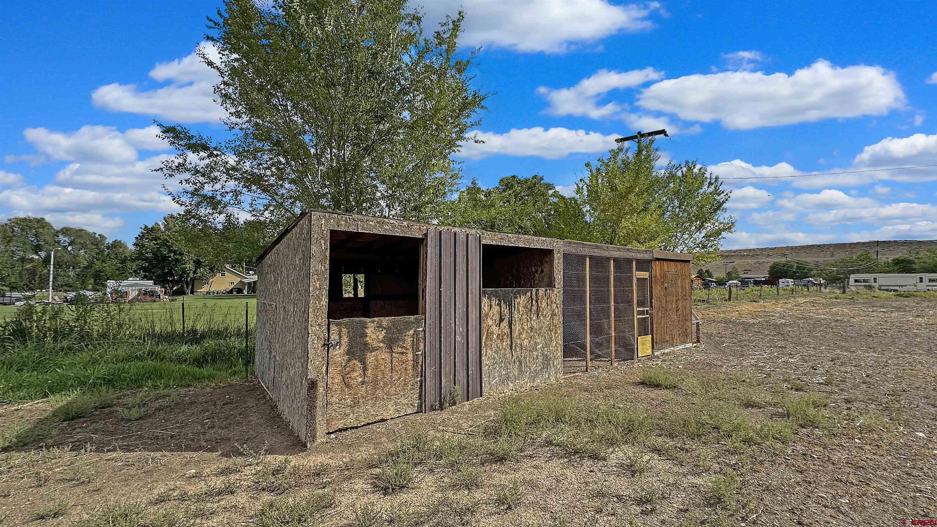 629 Norwood Road Montrose, CO 81403 - Photo 37 of 38 a view of a barn in the middle of a yard