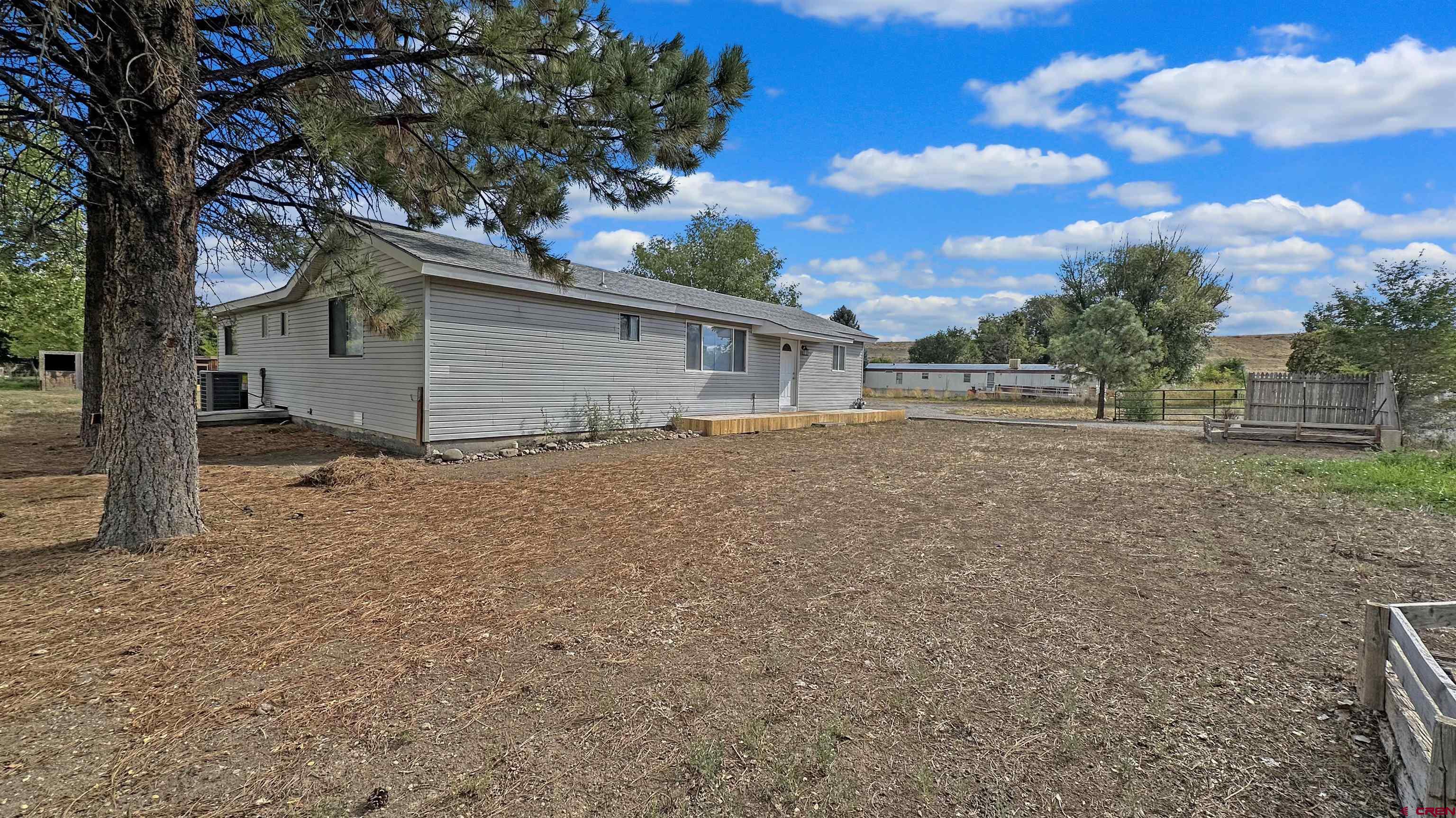 629 Norwood Road Montrose, CO 81403 - Photo 4 of 38 a backyard of a house with lots of green space