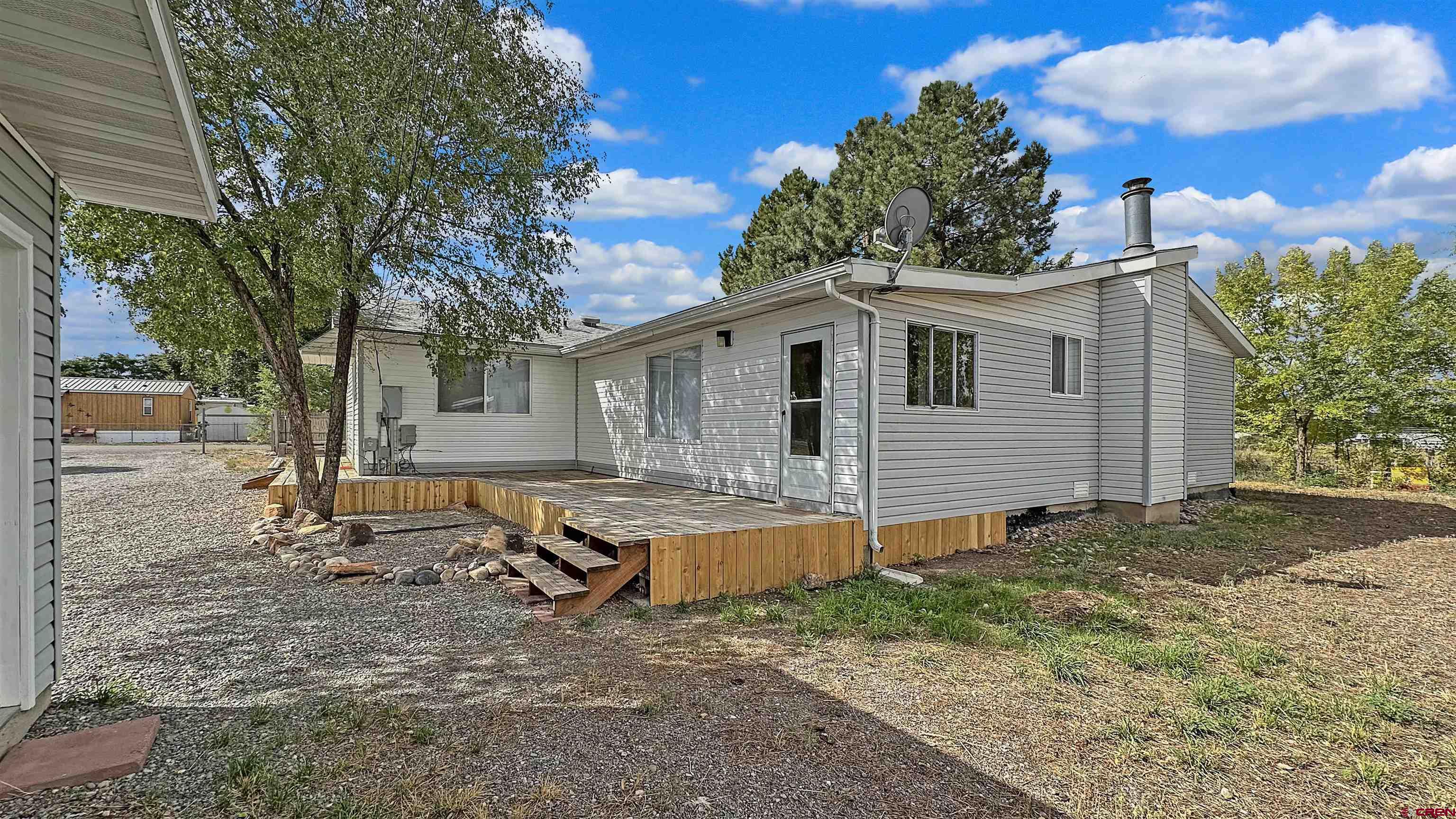 629 Norwood Road Montrose, CO 81403 - Photo 5 of 38 a view of a house with backyard and sitting area