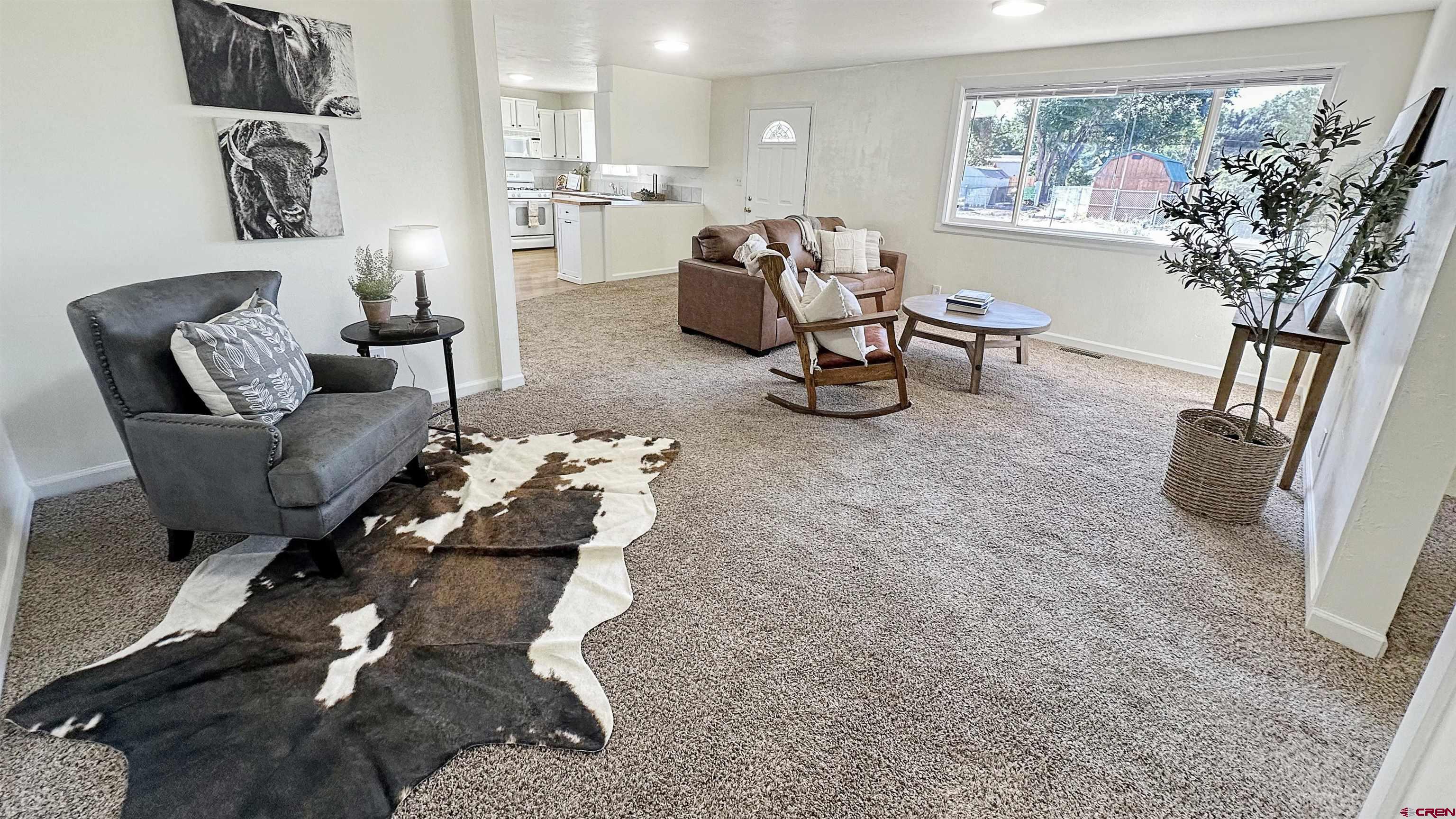 629 Norwood Road Montrose, CO 81403 - Photo 7 of 38 a living room with furniture and a potted plant