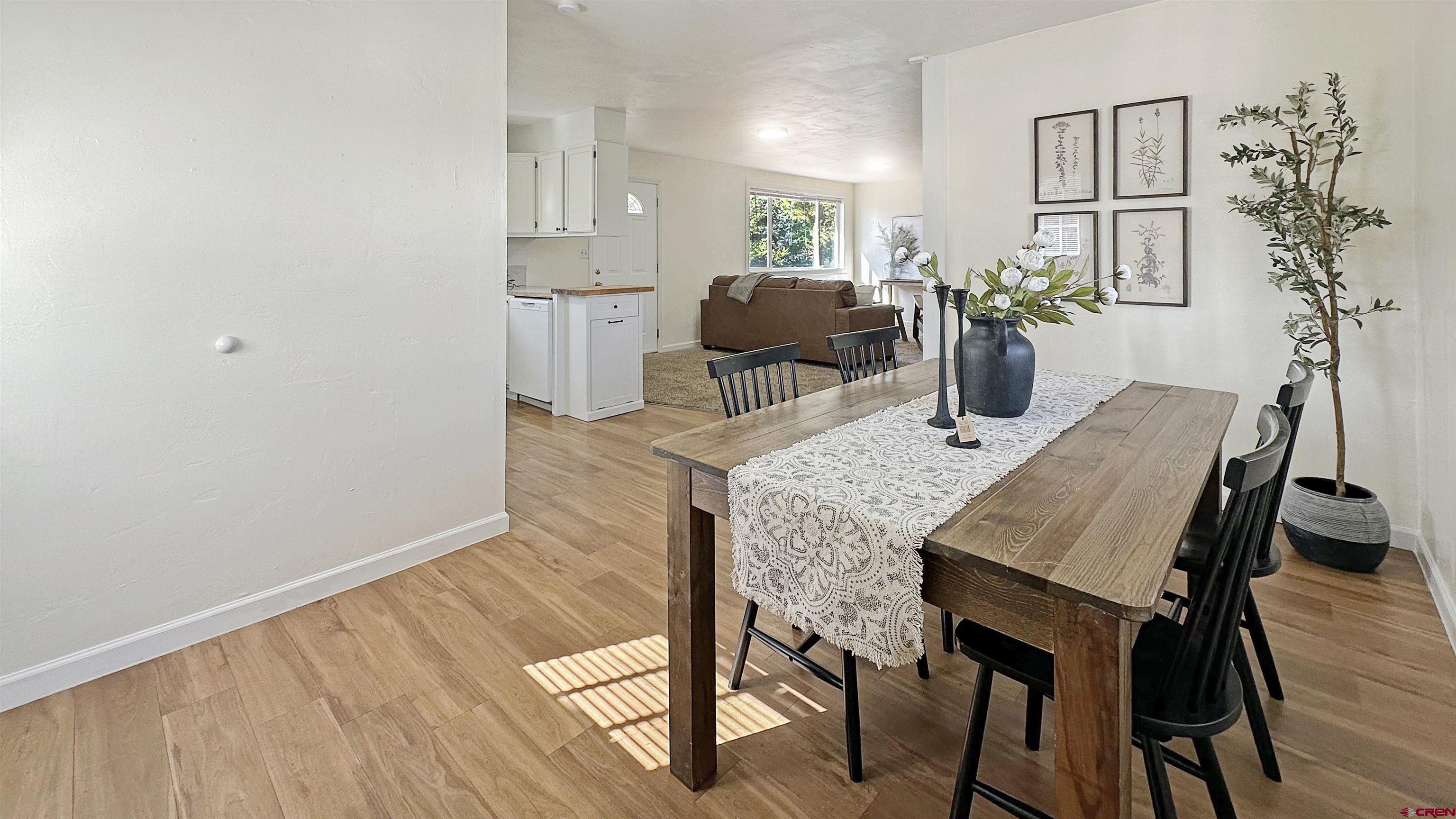 629 Norwood Road Montrose, CO 81403 - Photo 9 of 38 a view of a dining room with furniture and wooden floor