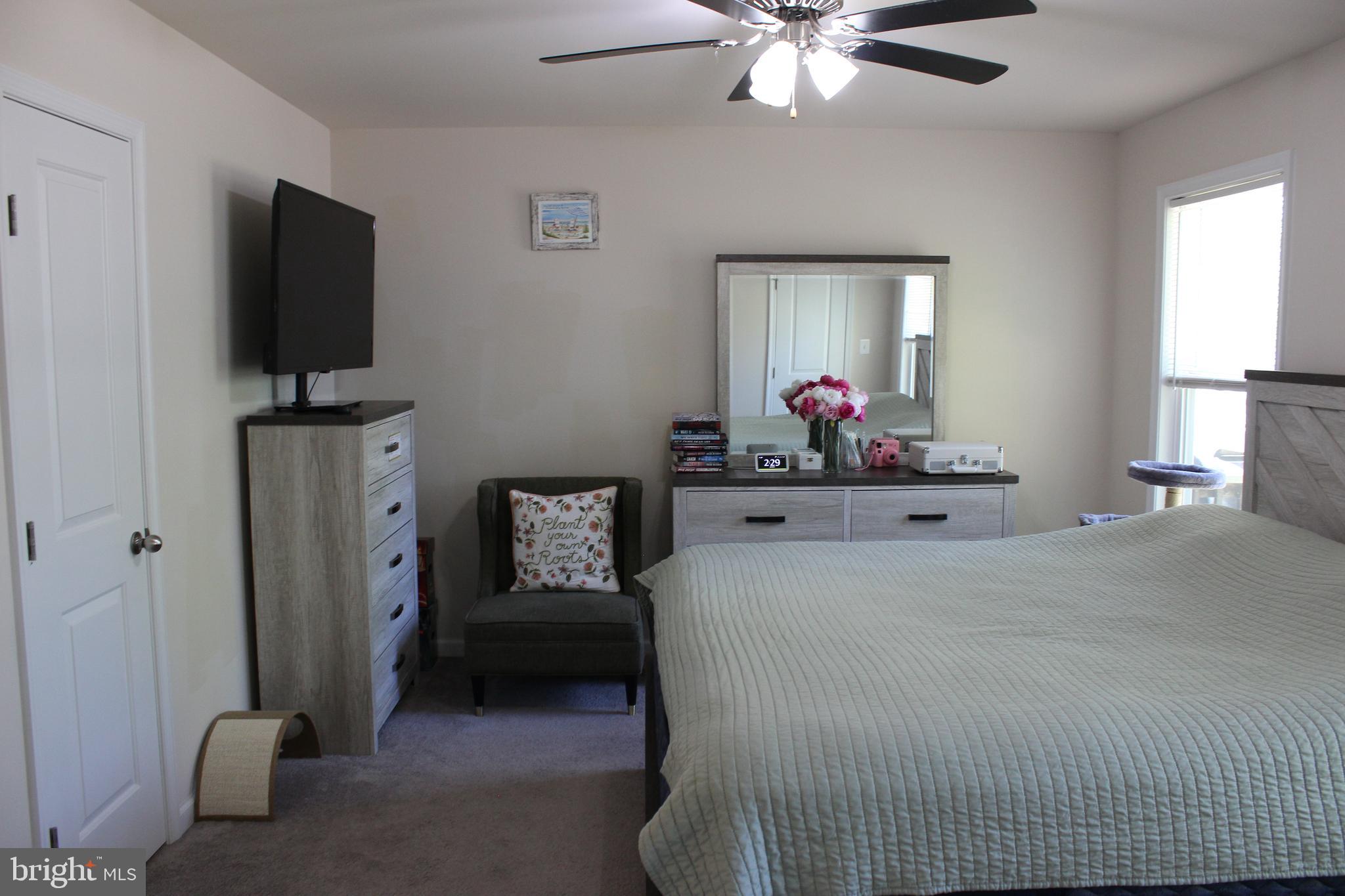 48 Rustic Lane Colonial Beach, VA 22443 - Photo 33 of 47 a bedroom with a bed and a flat screen tv