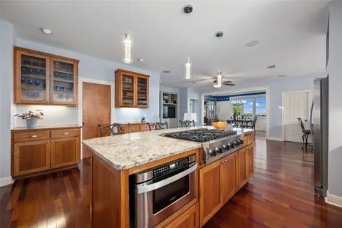 a kitchen with stainless steel appliances a refrigerator and a shelf