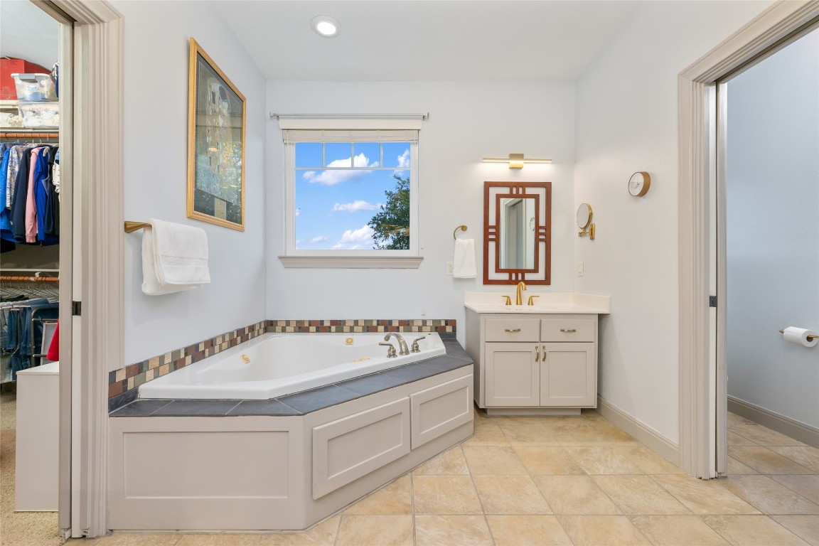 20403 Highland Lake Drive Lago Vista, TX 78645 - Photo 22 of 40 a spacious bathroom with a tub sink and mirror