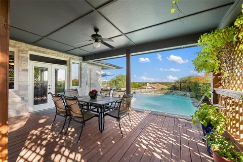 a view of a terrace with furniture and umbrella