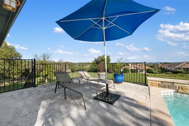 a view of a grassy field with trees
