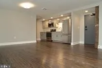 a view of a kitchen with a sink and a refrigerator