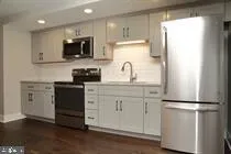 a kitchen with appliances a sink and a refrigerator