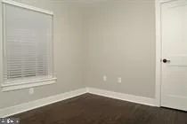 a view of a small space with wooden floor and a window