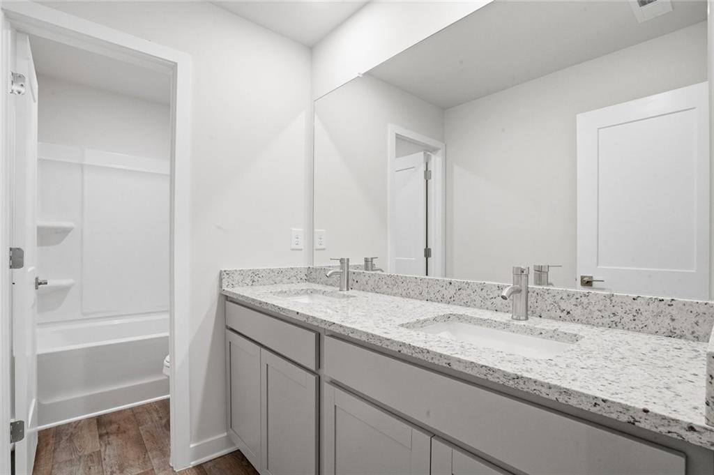 5351 Tolar Road South Fulton, GA 30213 - Photo 15 of 30 a bathroom with a granite countertop sink and a mirror