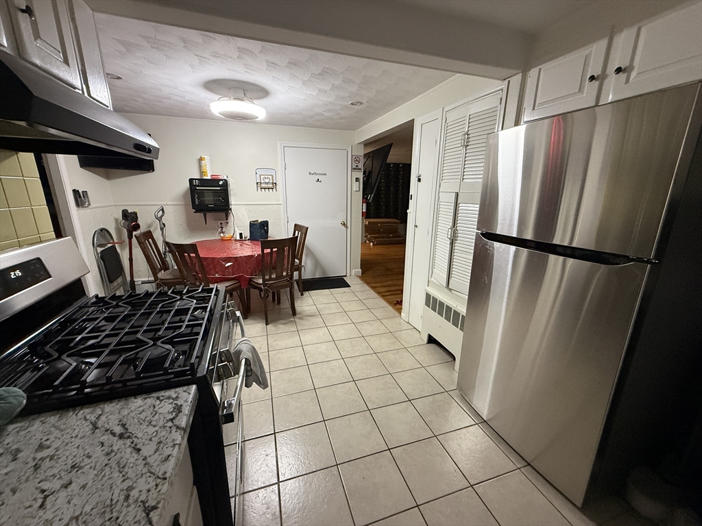 41 Shurtleff Street Revere, MA 02151 - Photo 4 of 12 a kitchen with stainless steel appliances a refrigerator and a stove top oven
