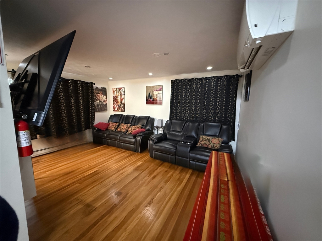 41 Shurtleff Street Revere, MA 02151 - Photo 6 of 12 a living room with furniture a flat screen tv and a rug