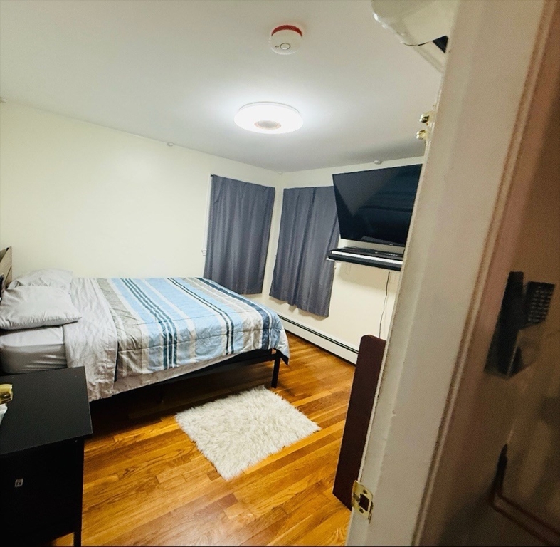 41 Shurtleff Street Revere, MA 02151 - Photo 10 of 12 a bed sitting in a bedroom next to a window