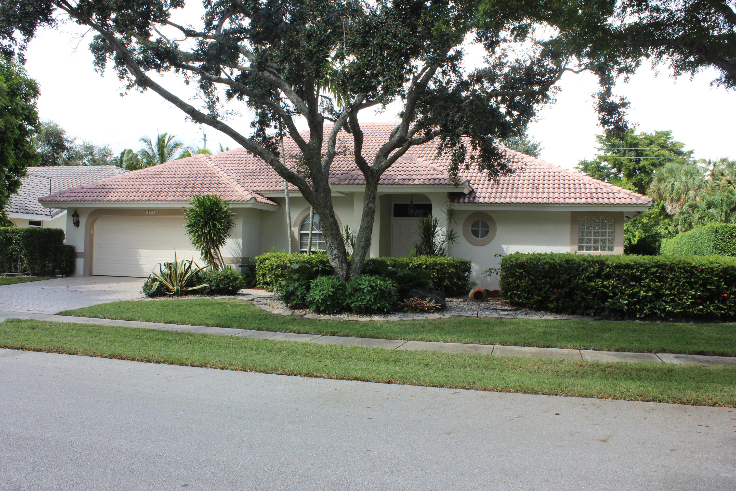 2671 Northwest 49th Street Boca Raton, FL 33434 - Photo 1 of 47 a front view of a house with a yard