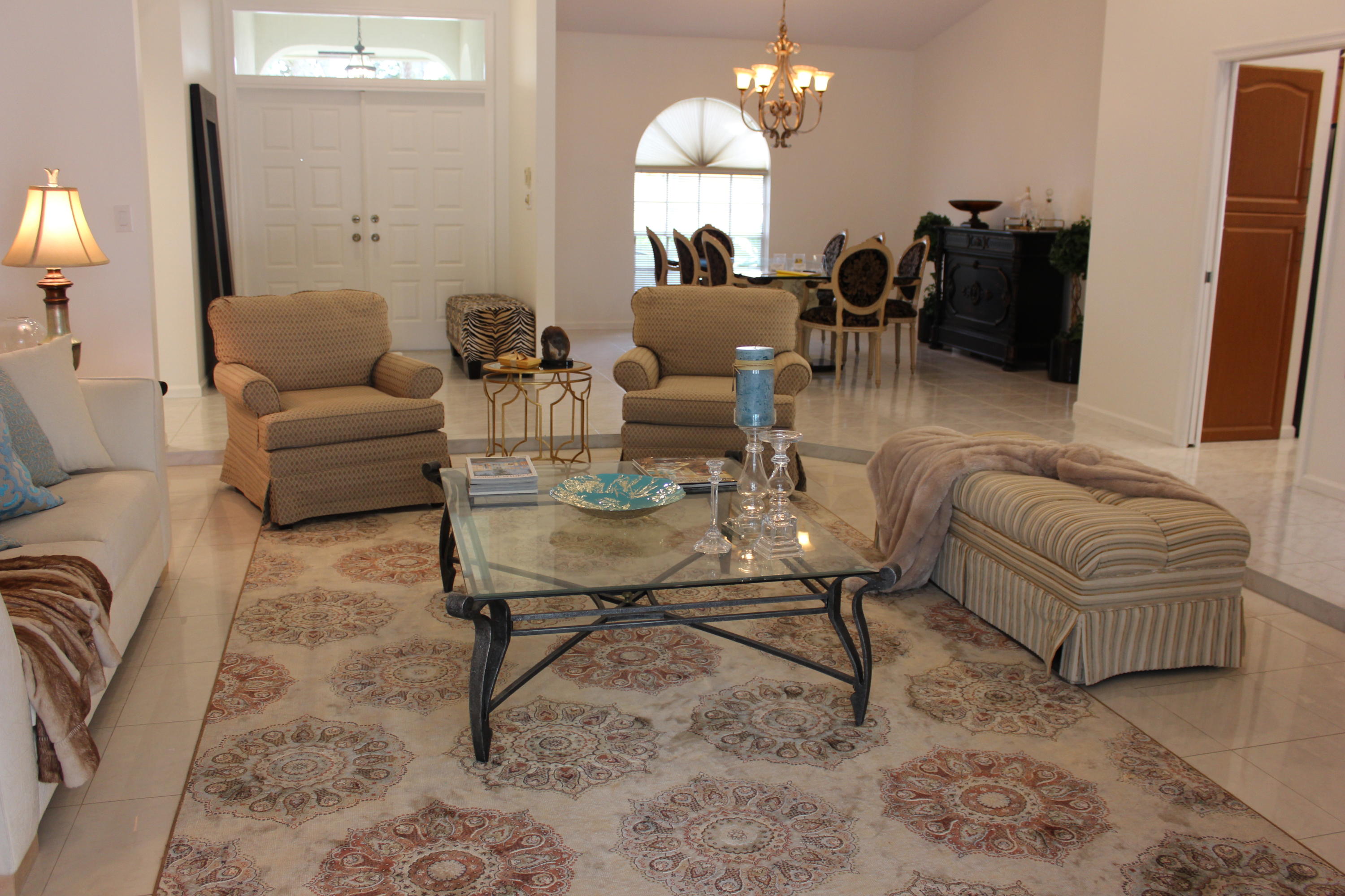 2671 Northwest 49th Street Boca Raton, FL 33434 - Photo 12 of 47 a living room with furniture potted plant and a chandelier