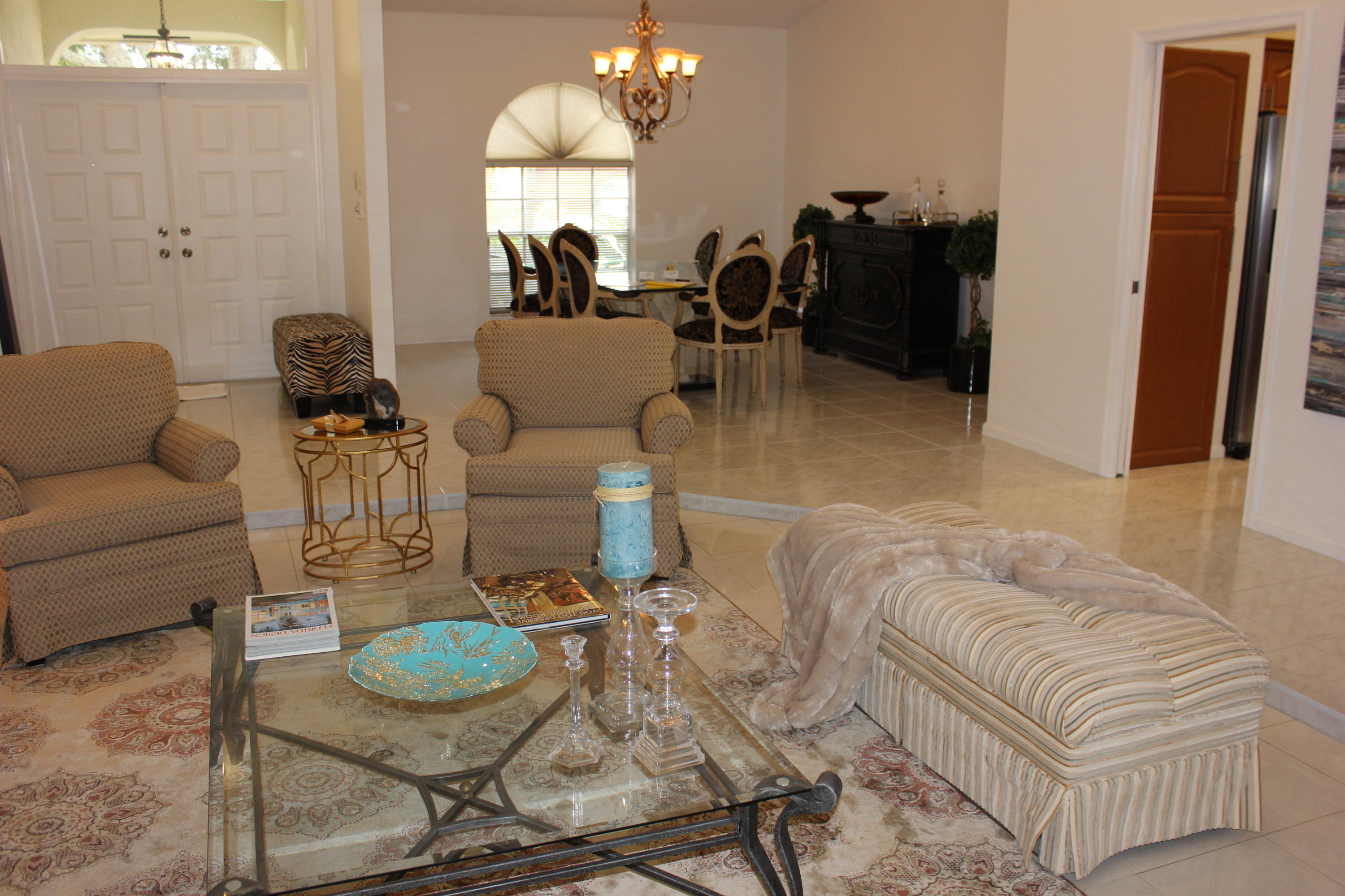 2671 Northwest 49th Street Boca Raton, FL 33434 - Photo 13 of 47 a living room with furniture and a chandelier