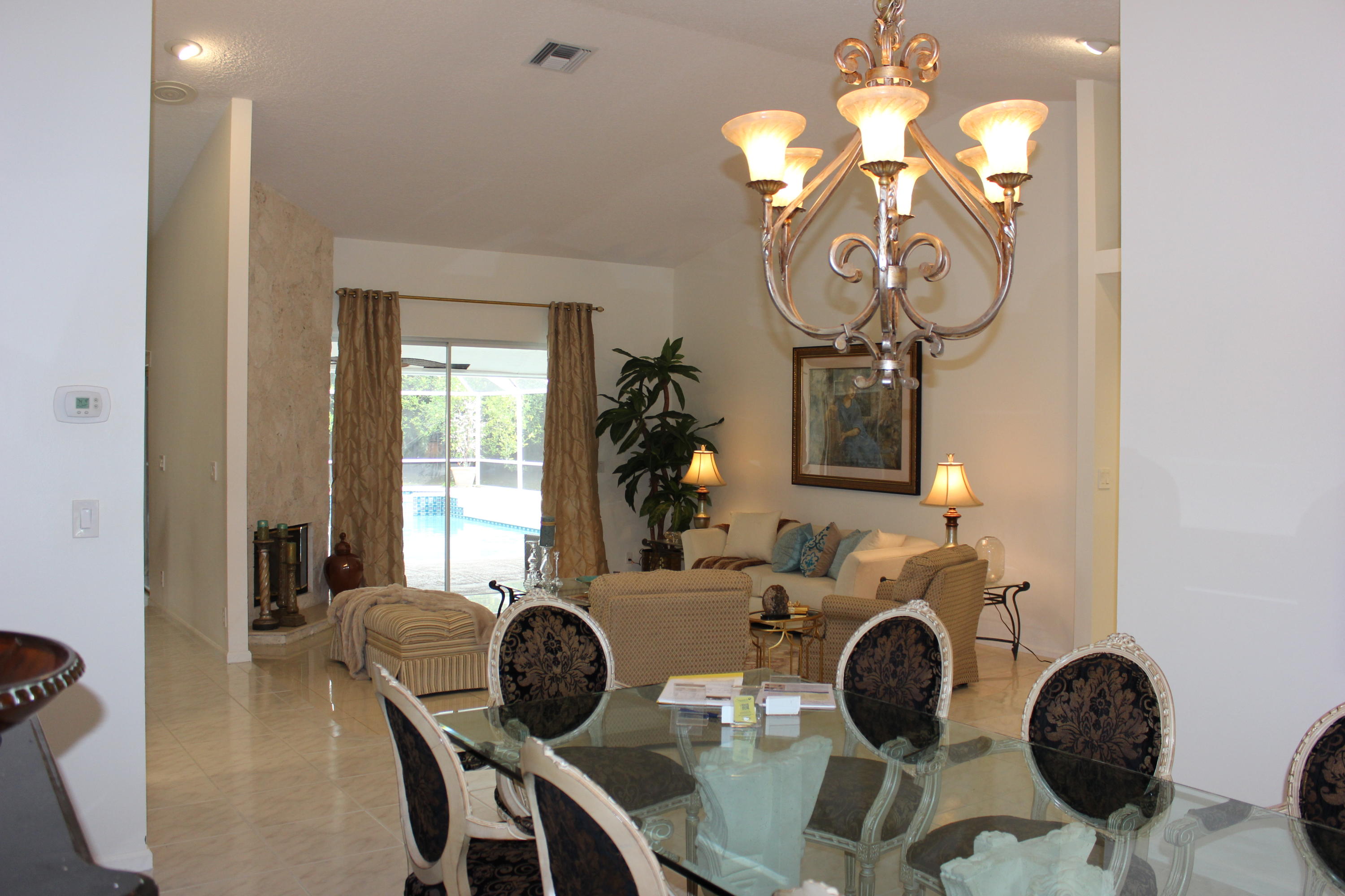 2671 Northwest 49th Street Boca Raton, FL 33434 - Photo 15 of 47 a view of a dining room with furniture and chandelier