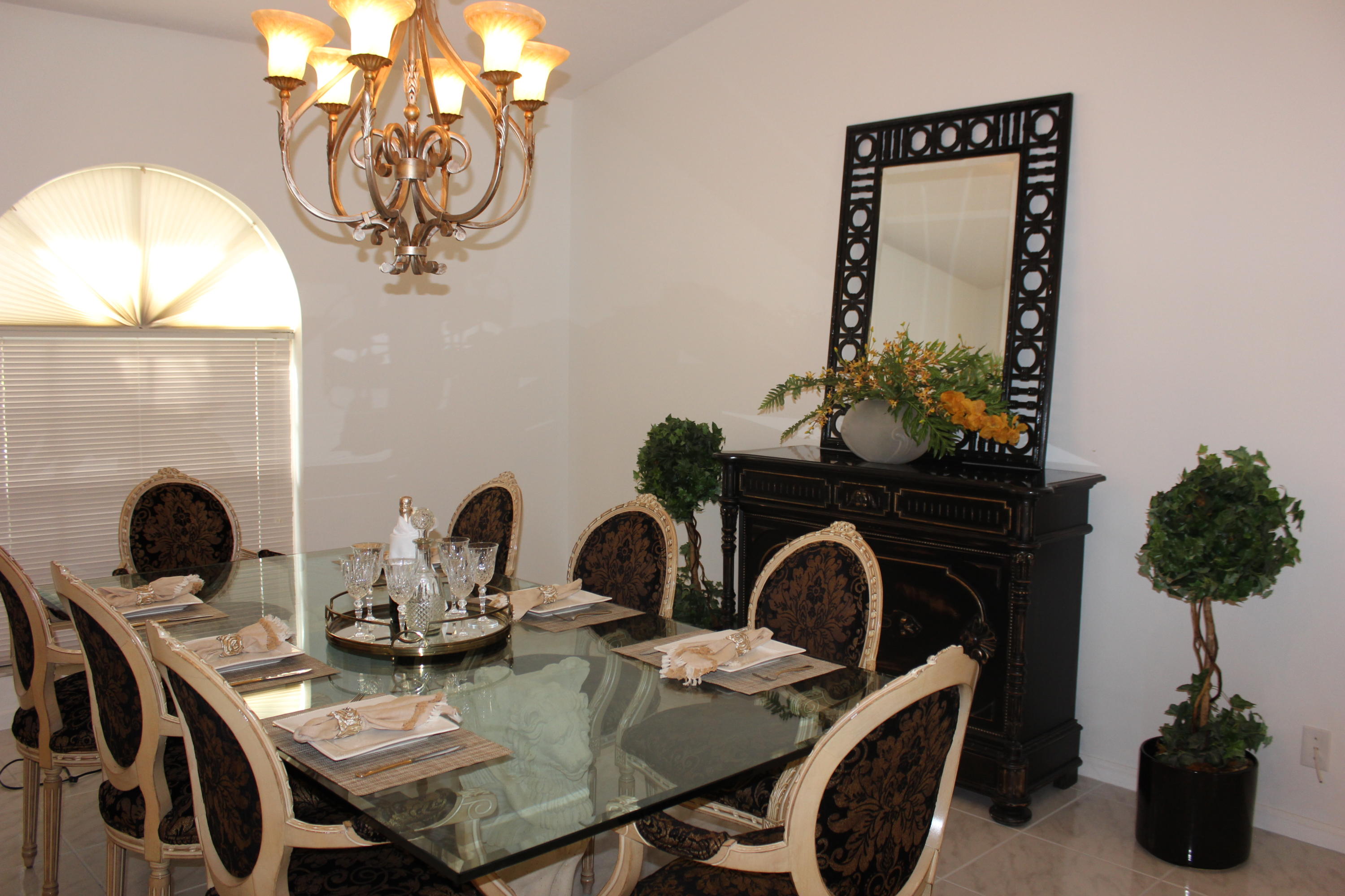 2671 Northwest 49th Street Boca Raton, FL 33434 - Photo 18 of 47 a view of a dining room with furniture and chandelier
