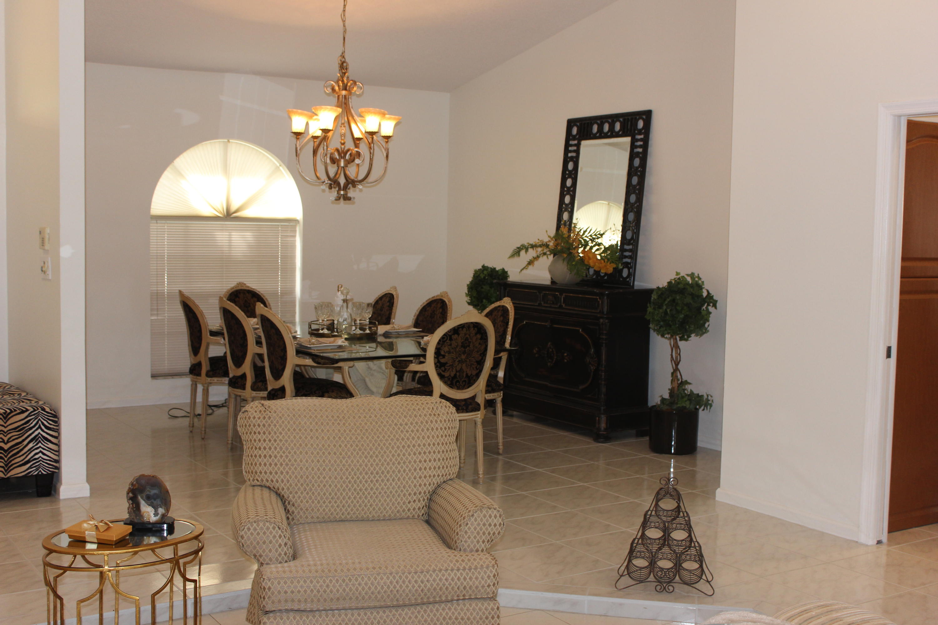 2671 Northwest 49th Street Boca Raton, FL 33434 - Photo 19 of 47 a living room with couches chairs and a chandelier