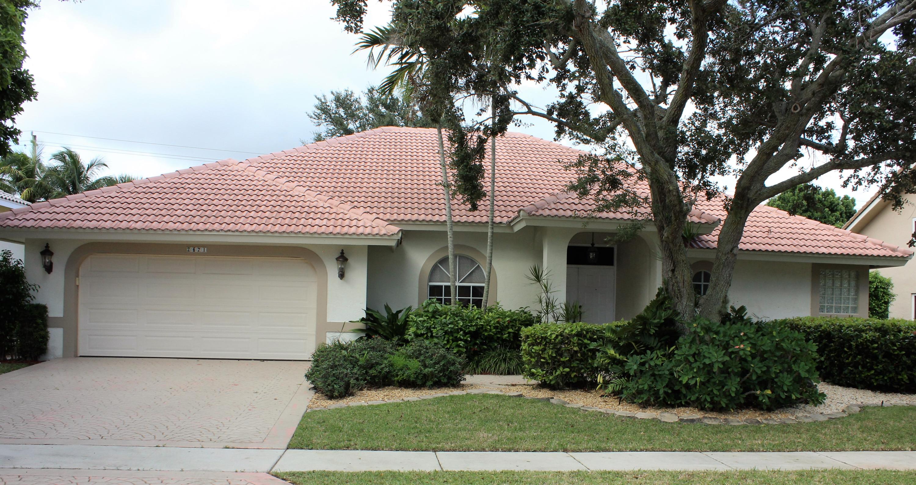 2671 Northwest 49th Street Boca Raton, FL 33434 - Photo 2 of 47 a front view of a house with garden