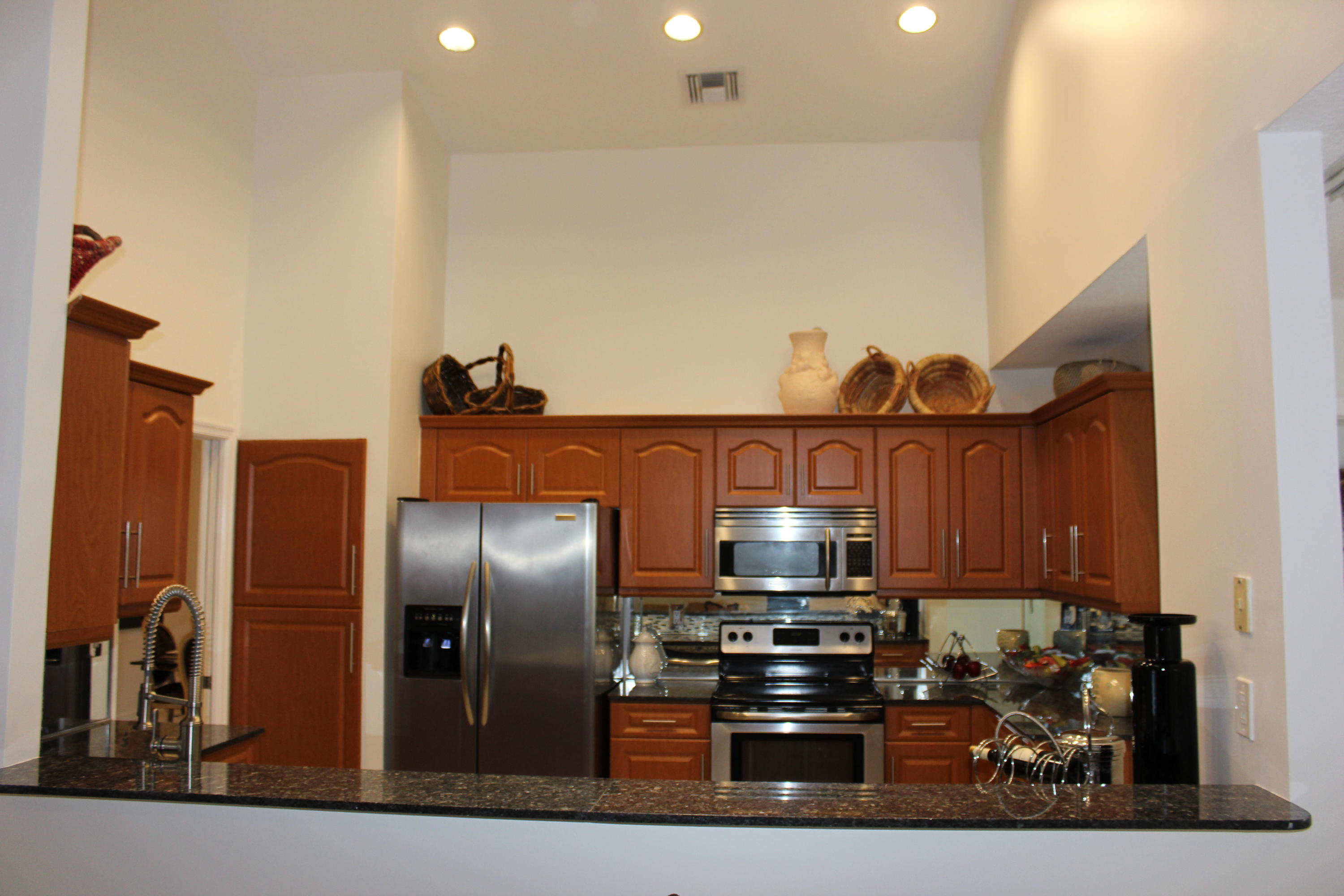 2671 Northwest 49th Street Boca Raton, FL 33434 - Photo 22 of 47 a kitchen with stainless steel appliances granite countertop a refrigerator and a stove