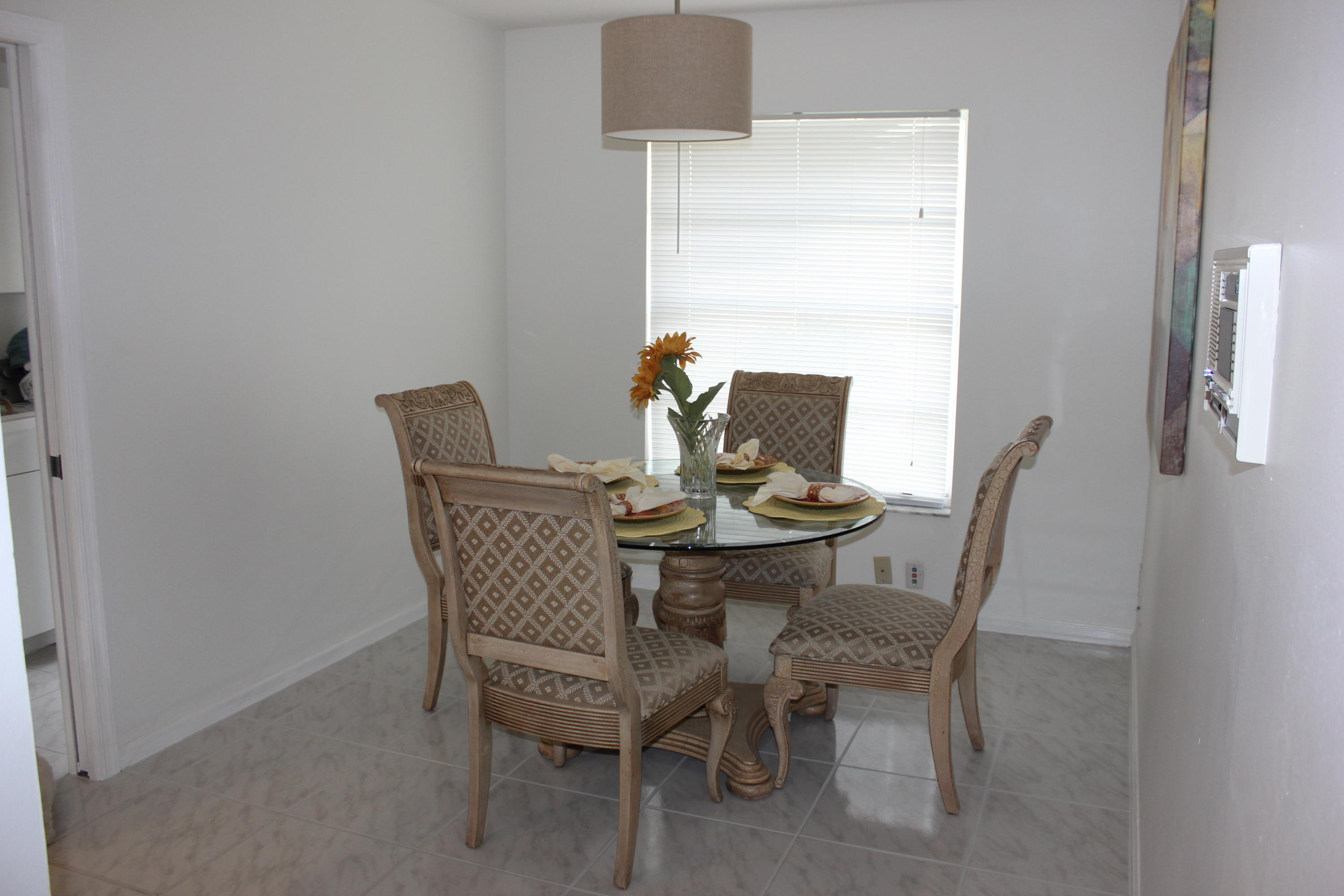 2671 Northwest 49th Street Boca Raton, FL 33434 - Photo 23 of 47 a dining room with furniture and a window