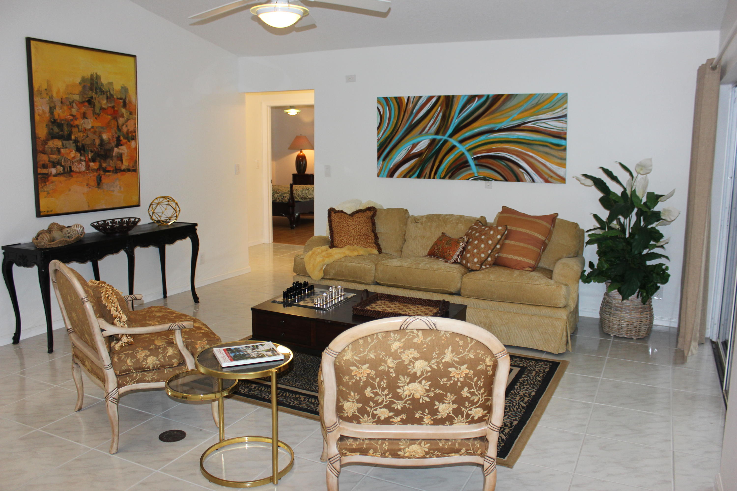 2671 Northwest 49th Street Boca Raton, FL 33434 - Photo 25 of 47 a living room with furniture and a painting on the wall
