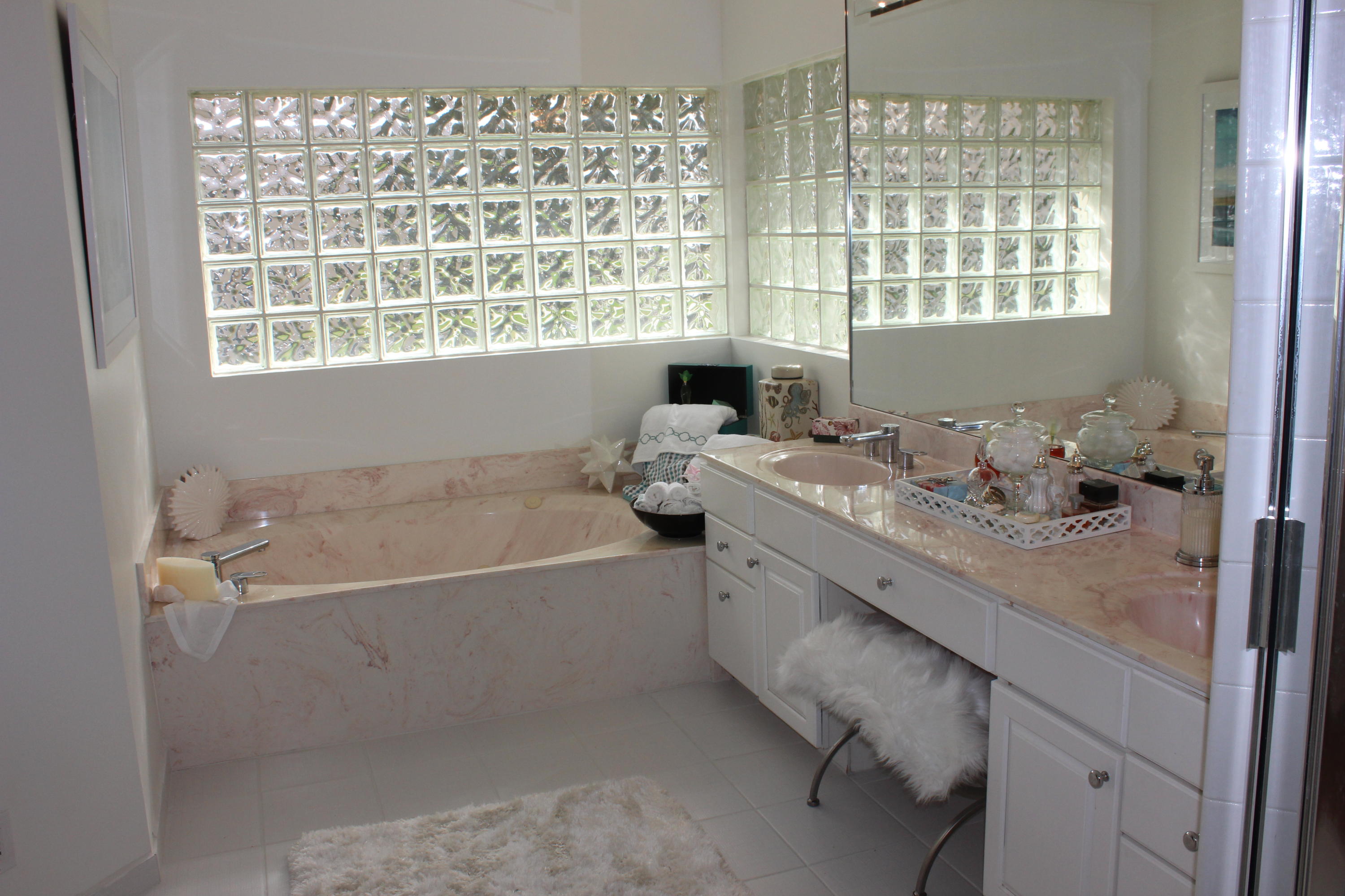 2671 Northwest 49th Street Boca Raton, FL 33434 - Photo 30 of 47 a bathroom with a granite countertop tub sink and next to a window