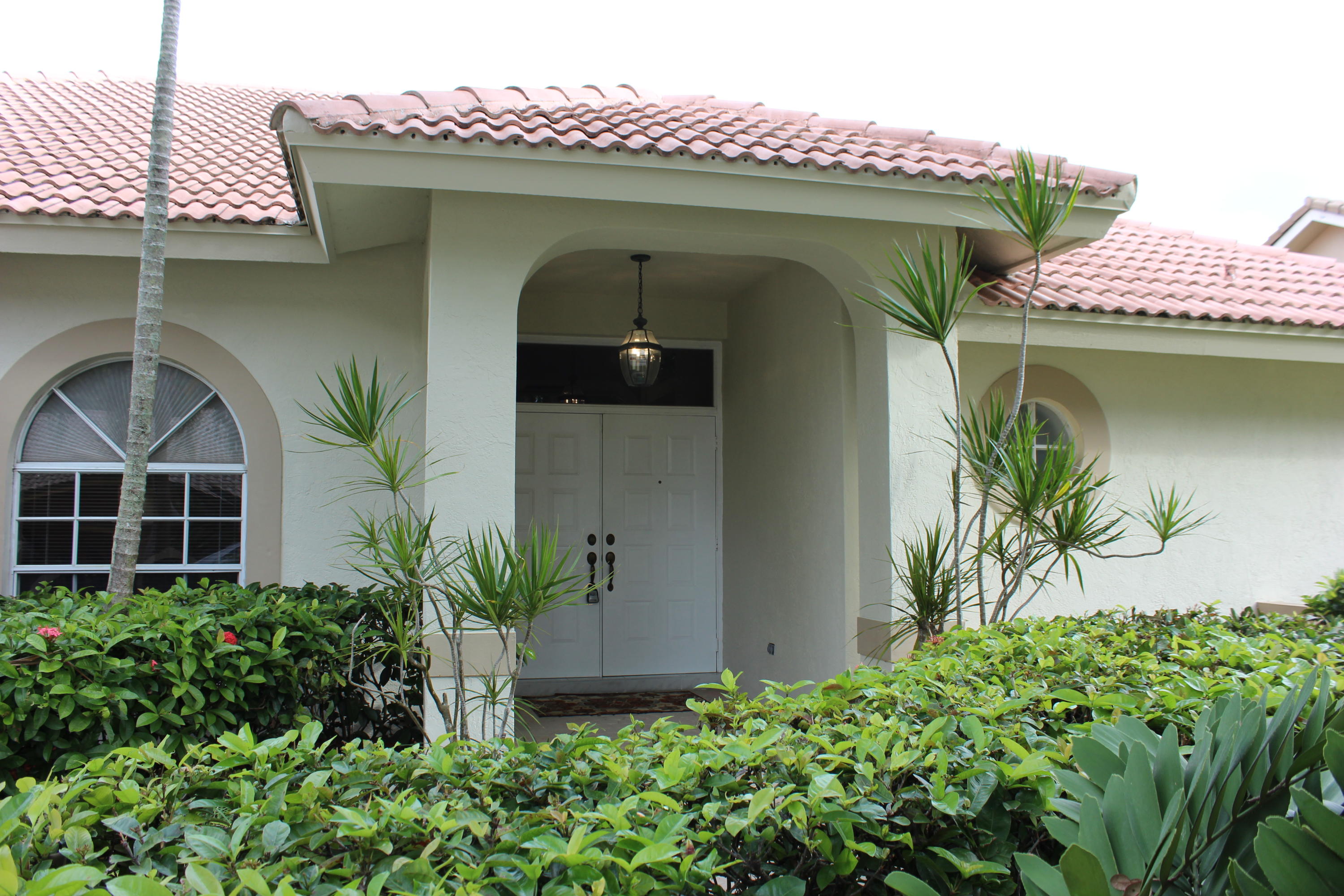 2671 Northwest 49th Street Boca Raton, FL 33434 - Photo 3 of 47 a front view of a house with plants