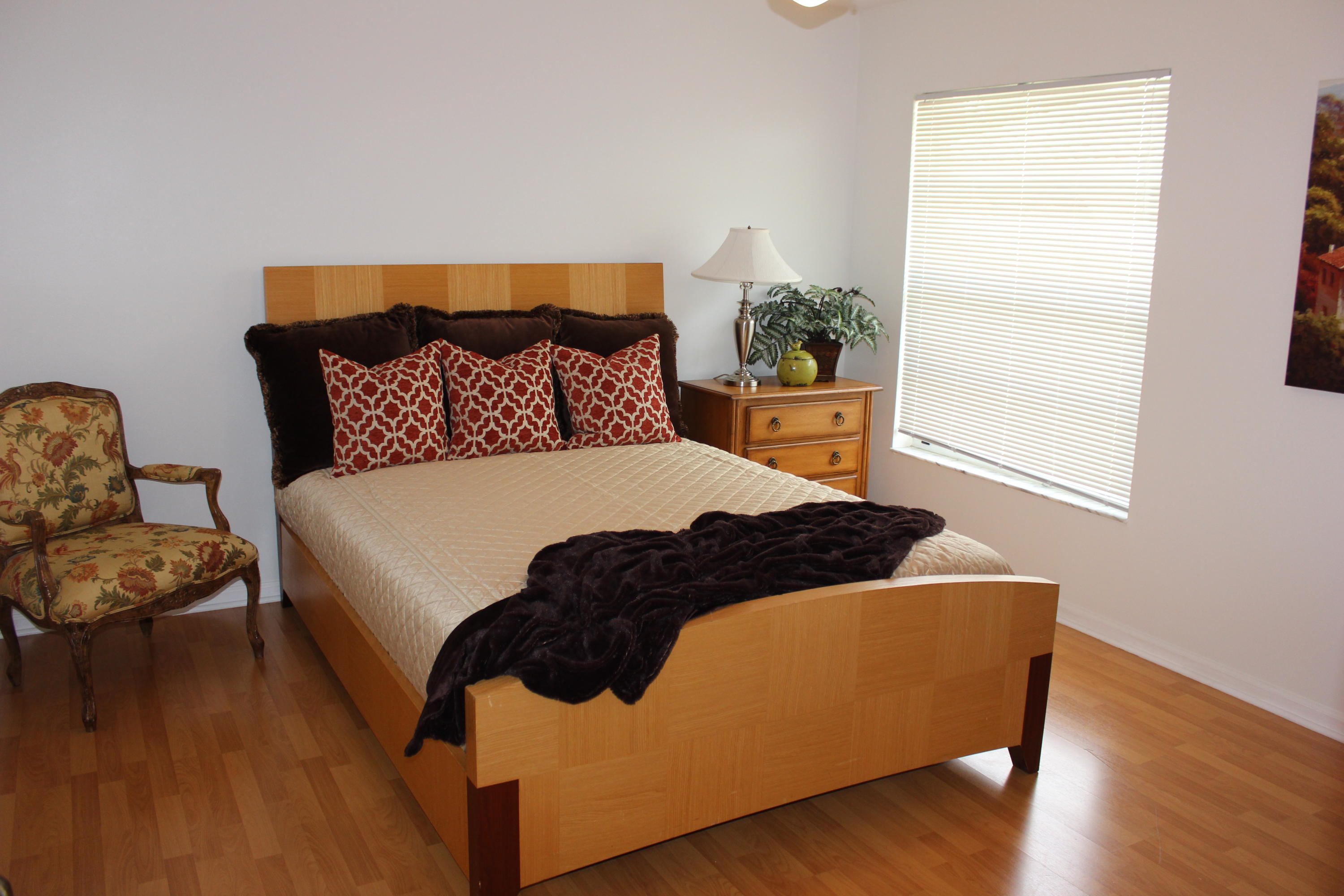 2671 Northwest 49th Street Boca Raton, FL 33434 - Photo 36 of 47 a bedroom with a bed lamp and a potted plant