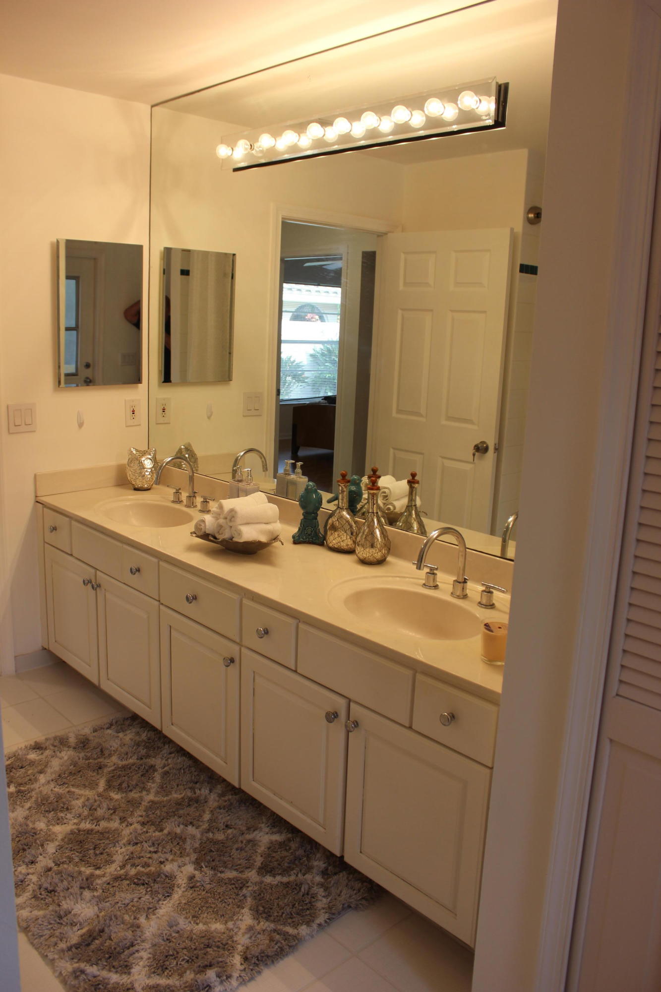 2671 Northwest 49th Street Boca Raton, FL 33434 - Photo 38 of 47 a bathroom with a double vanity sink and mirror