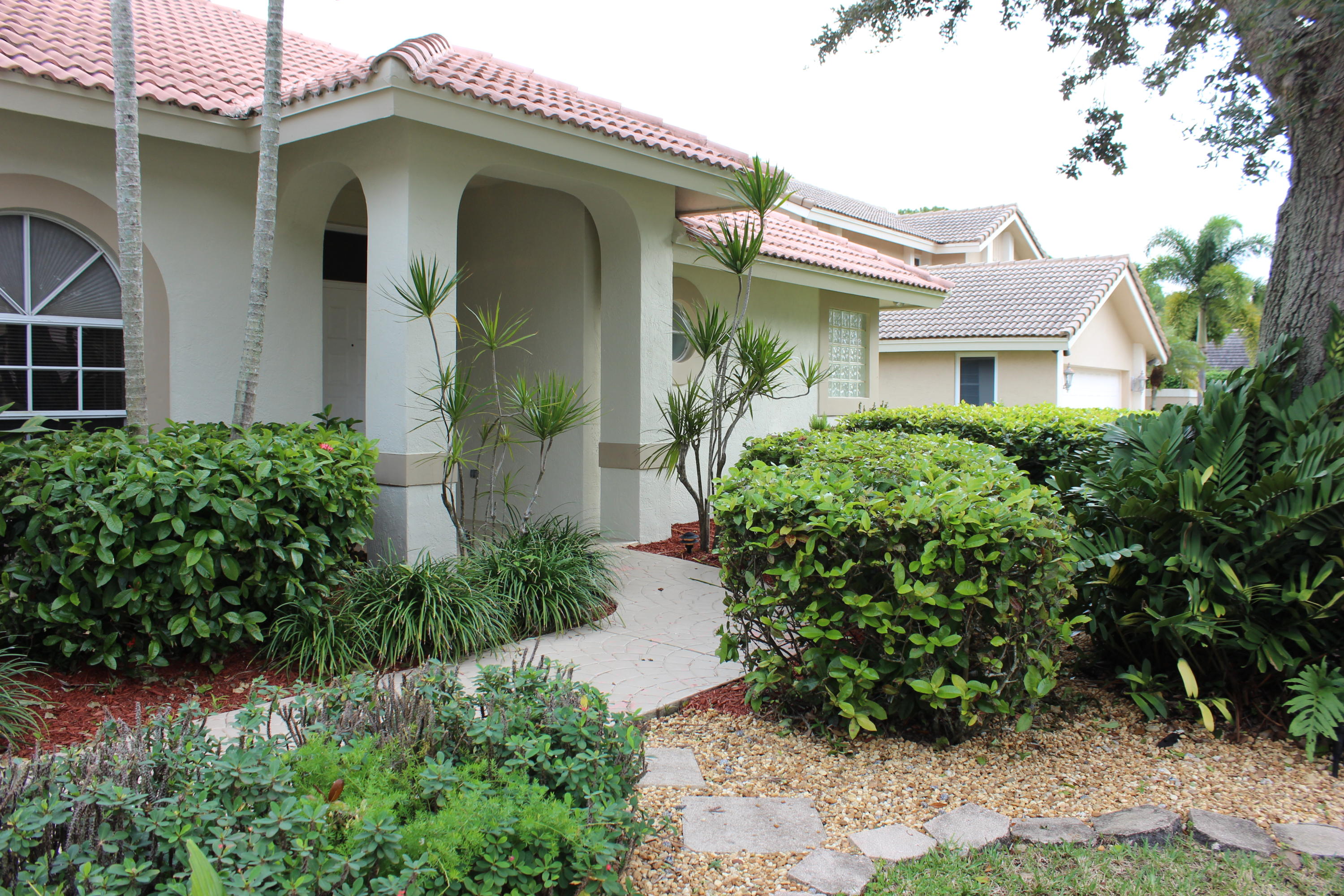 2671 Northwest 49th Street Boca Raton, FL 33434 - Photo 4 of 47 a front view of a house with garden