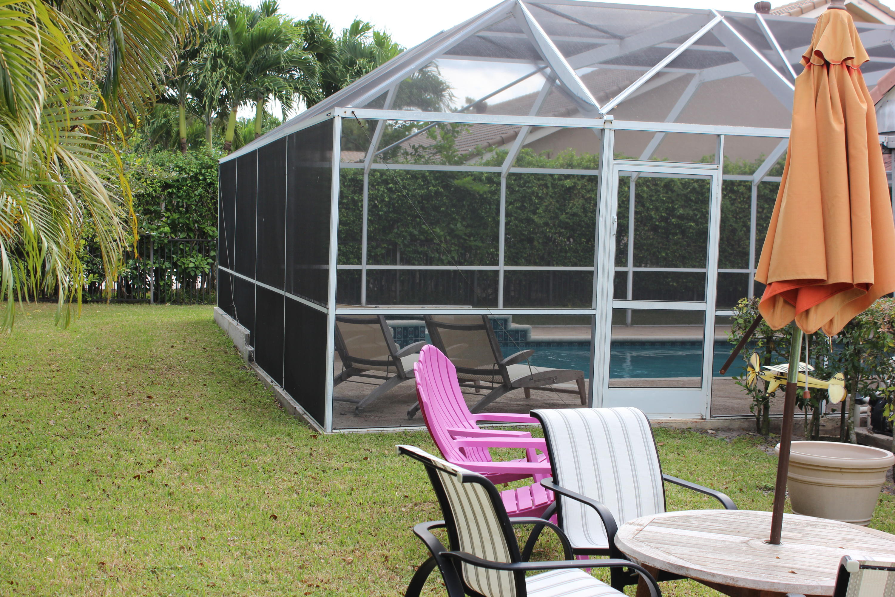 2671 Northwest 49th Street Boca Raton, FL 33434 - Photo 7 of 47 a view of an chairs and table in the backyard